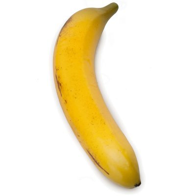 En mogen banan med gula och bruna fläckar mot vit bakgrund.