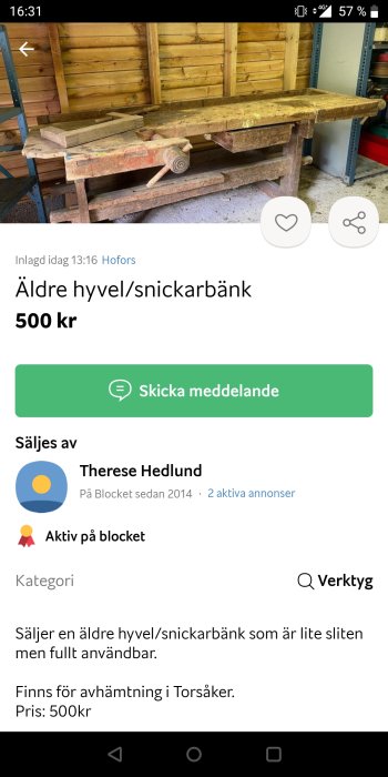 Äldre snickarbänk med synliga bruksspår och verktyg, i en verkstadsinredning.