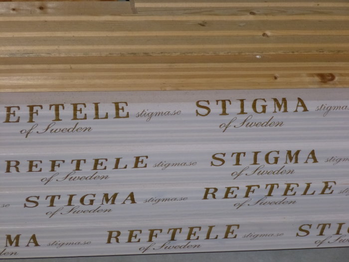 Träpanel och paket med texten "STIGMA of Sweden" på ett byggprojekt.