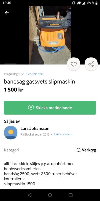 Orangefärgad slipmaskin med svart topp på betonggolv i ljus miljö, skugga synlig.