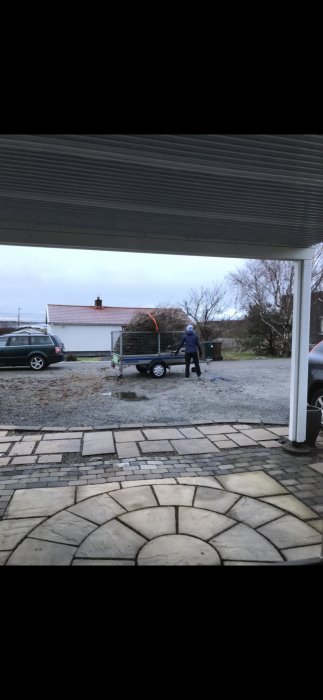 Ojämn stenläggning framför husentré med synliga spår av sättningar och ojämnheter.