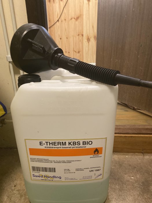 En stor behållare med E-THERM KBS BIO köldbärarsprit ansluten till en pump.