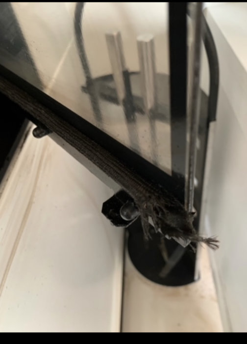 Damaged sealing strip on window frame showing signs of cracking and deterioration.