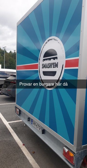 Bakdel av en matvagn med namnet "SMASH'EM" och en bild av en hamburgare, parkerad vid Jula Kungälv.