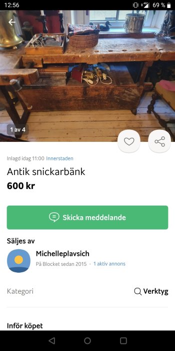 Antik snickarbänk till salu, sliten yta med verktyg och korg ovanpå.