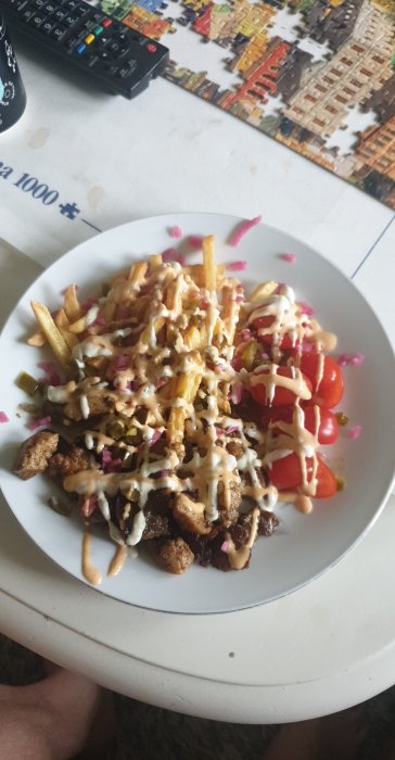 Tallrik med kebab, karré, kyckling, pommes och sås, toppad med hackad jalapeno och picklad rödlök.