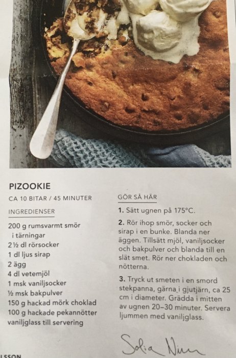 Recept på pizookie med ingredienser och steg-för-steg-instruktioner, delvis uppäten i gjutjärnspanna.