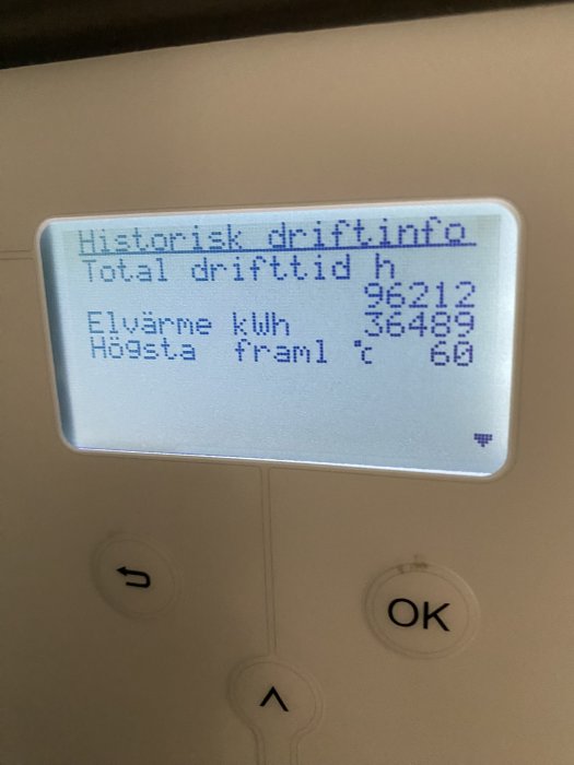 Display visar historisk driftinfo, total drifttid och elförbrukning på en värmepump eller liknande enhet.