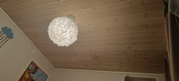 Tak med ny monterad glespanel och en designerlampa, inomhus.