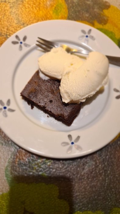 En LCHF-brownie med glass på en tallrik, bredvid en gaffel.