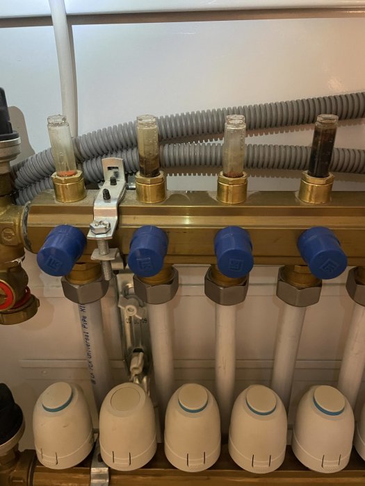 Rörsystem med mätklockor, ventiler och rörkopplingar för vatteninstallation.