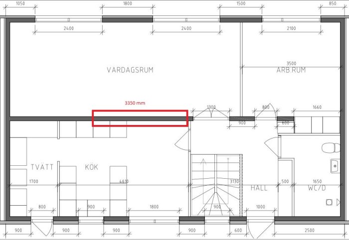 Arkitektonisk ritning av en lägenhetsplan med markerad vägg i vardagsrummet.