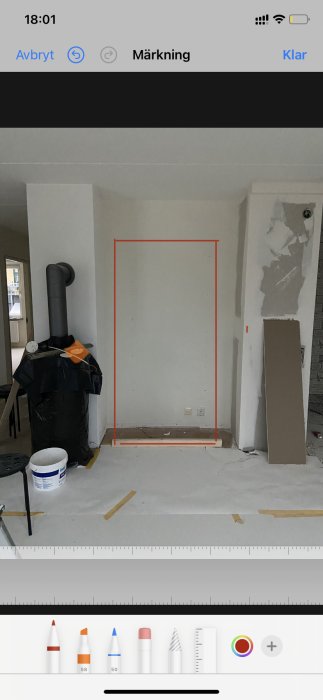 Ett markerat utrymme i en vägg med måttlinjer för planering av vitrinskåpsinstallation i renoveringsprojekt.