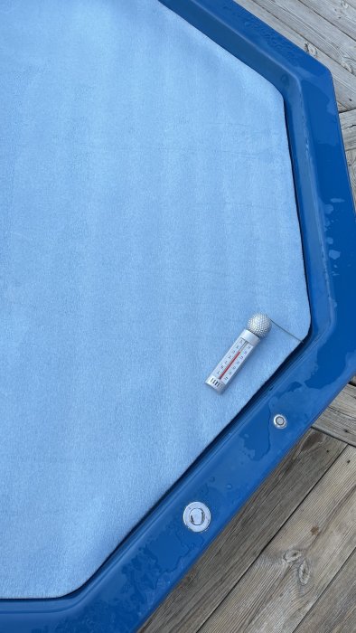 5 mm tjock foam folie som flyter på poolvatten med termometer som visar temperaturen.