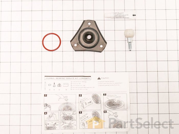 Reservdelar och instruktion för journalbearing service kit utspridda på rutigt underlag.