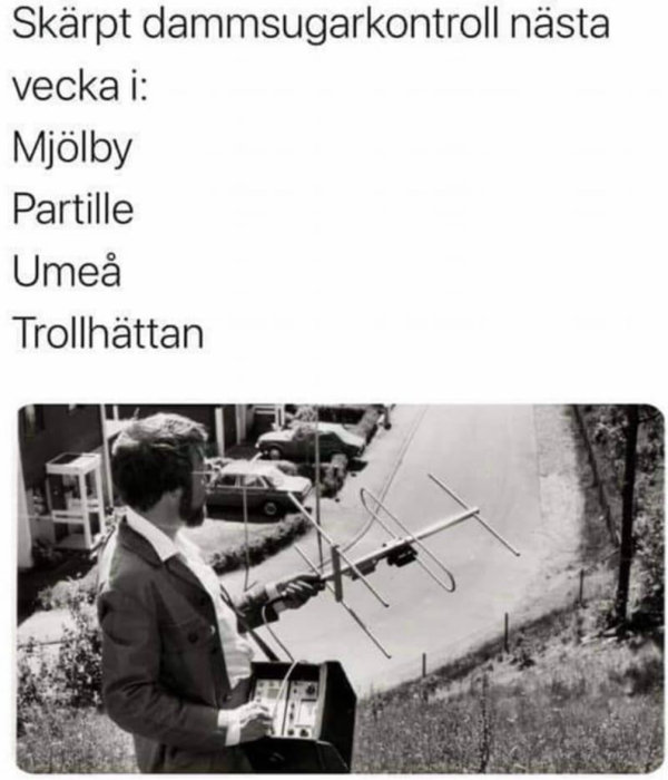 Man med antennliknande verktyg, humoristisk text om dammsugarkontroll, svartvitt foto, retro känsla.