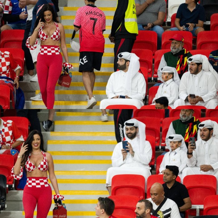 Kvinnor i kroatiska färger på läktaren, män i traditionell arabisk klädsel tittar på, fotbollsarena.
