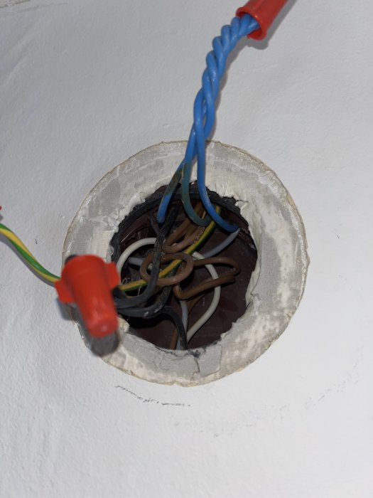 Öppen elinstallation med utsatta kablar och WAGO-klemmor i en vägg.