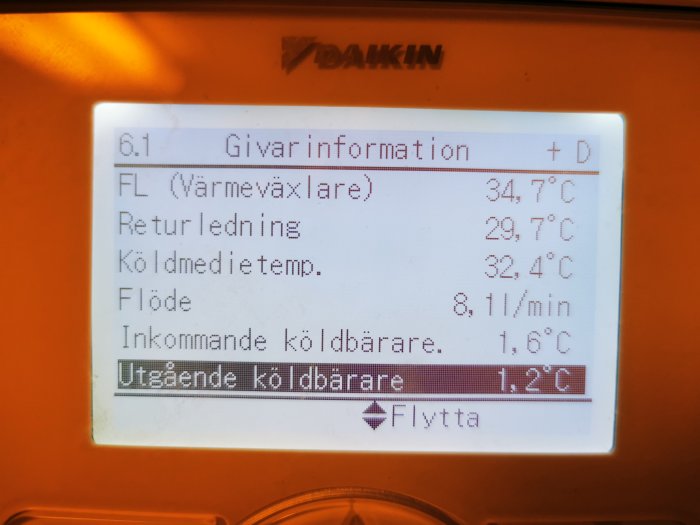 Digital display visar temperaturinformation för en värmepump eller kylsystem på svenska.