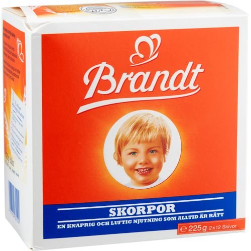 Förpackning av Brandt Skorpor med barns leende ansikte, orange och vit design, text "En knaprig och luftig njutning".