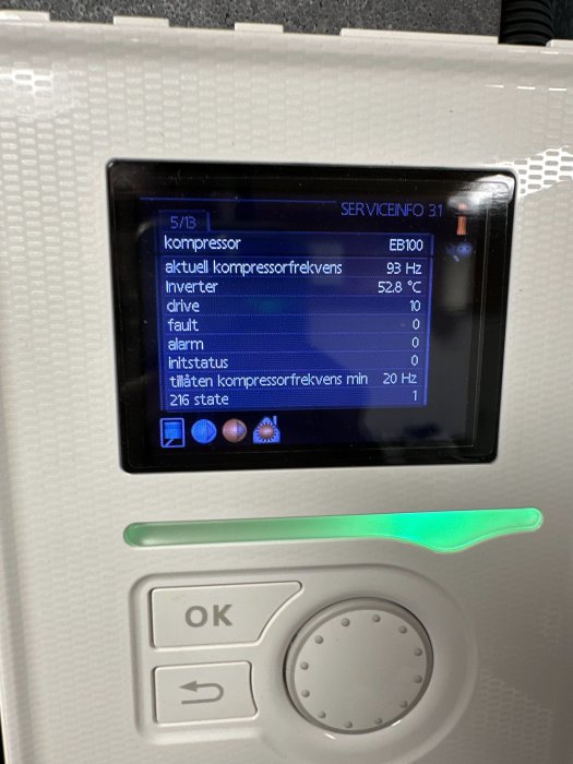 Digital display visar teknisk information, kanske för en kompressor, med knappar för användarinteraktion.