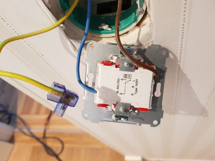 Öppen elektrisk strömbrytare, kablar anslutna, vägginstallation, säkerhetsrisk, oavslutat elektriskt arbete.