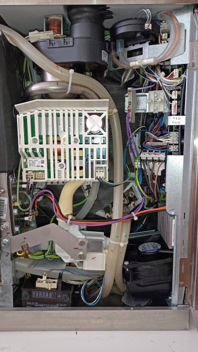 Inre elektronik av en komplex apparat, kablar, kretskort, blåsare, säkringar, och mekaniska komponenter.