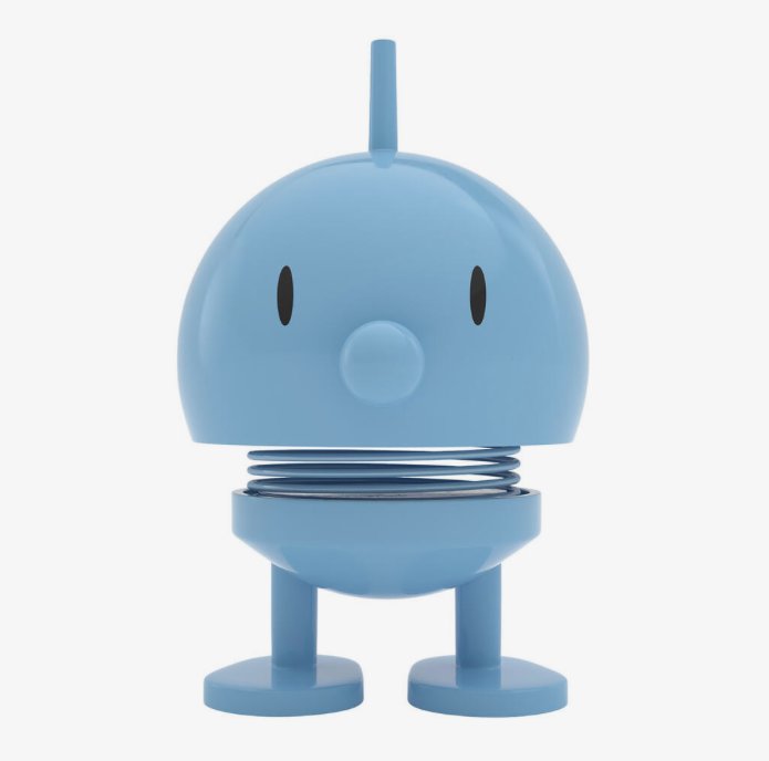 Blå tecknad figur, rund kropp, fjädrar, ser ut som en söt robot eller leksak.