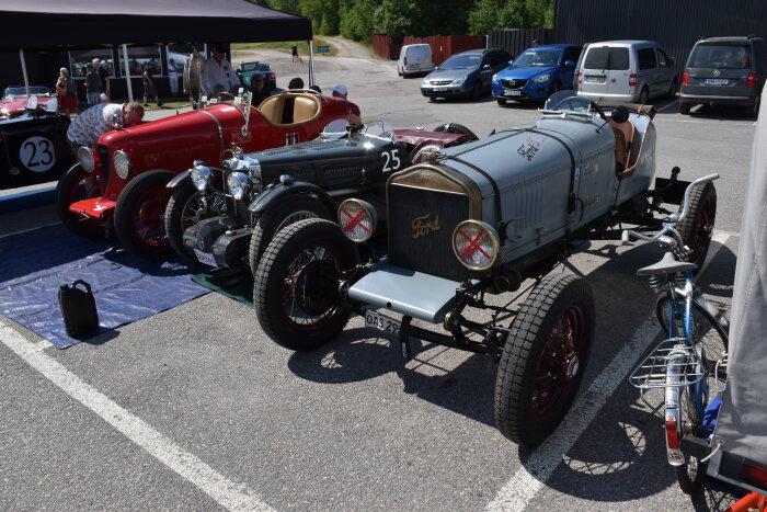 Bilklassiker, Ford, tävlingsbil, utomhusevenemang, andra fordon, blå himmel, människor, racerstämning, cykel, parkeringsplats.