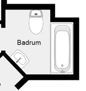 Planritning av ett badrum med toalett, handfat och badkar. Enkel, svartvit, schematisk illustration.