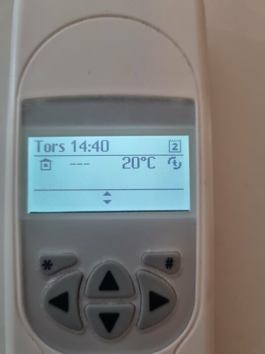 Digital termostat visar "Tors 14:40" och inomhustemperatur på "20°C". Knappar för inställningar syns nedanför.