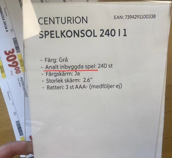 Produktförpackning för spelkonsol, grå, innehåller 240 spel, färgskärm, 2.6 tum, AAA-batterier behövs.