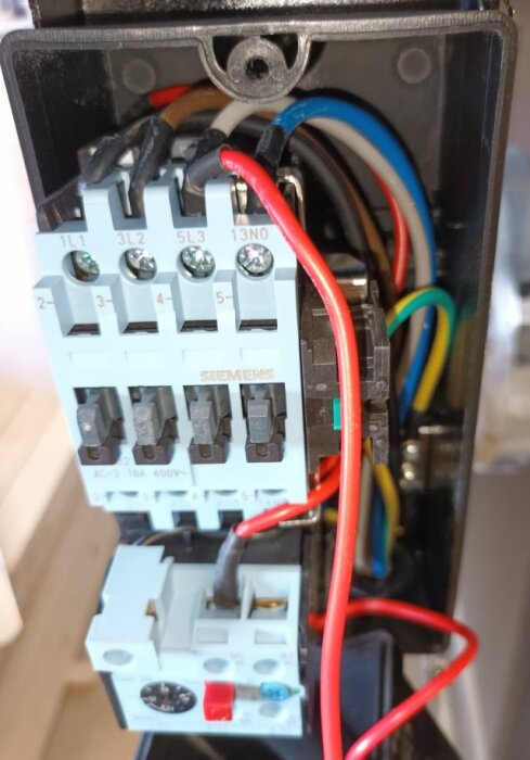 Elektrisk kopplingsdosa med Siemens komponenter och färgkodade kablar.