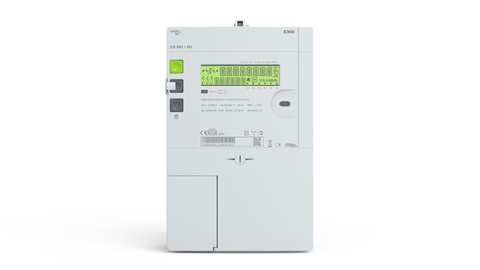 Vit elektrisk enhet med display, knappar och portar, troligen en väggmonterad kontrollpanel eller mätare.