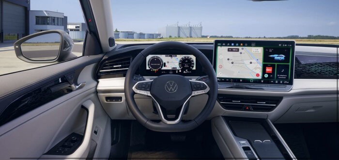 Inredning av modern bil med digital instrumentbräda och infotainmentsystem, rymlig, ren design, Volkswagen-logotyp.