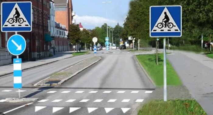 Stadsväg, cykelöverfarts-skyltar, markeringar, grönområde, stadsbebyggelse, klar dag.