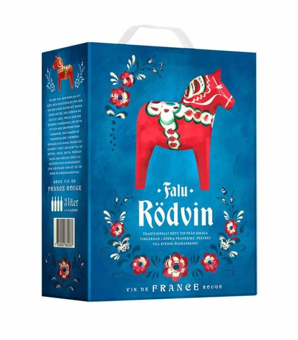 En box med Falu Rödvin, traditionellt rött vin, 3 liter, Dala häst design, blommönster, fransk text.