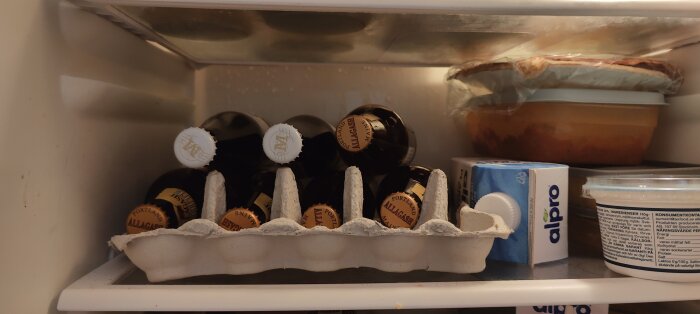 Kylen innehåller ett äggkartong med flaskor, matlådor, Alpro sojadryck och andra köksvaror.