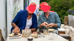 Två personer sitter ute och njuter av handarbete tillsammans vid ett bord med fika.