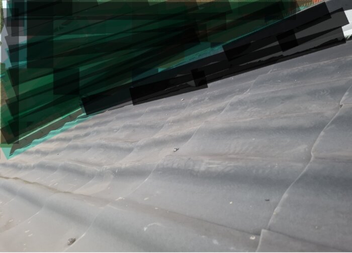 En delvis pixelerad bild visar en yta med diagonala skuggor och oregelbundna strukturer, redigerat med gröna toner.