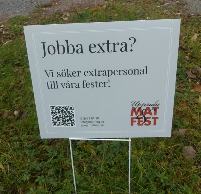 Skylt erbjuder extraarbete på fester, med QR-kod, kontaktinformation och logotyp, placerad på gräs.