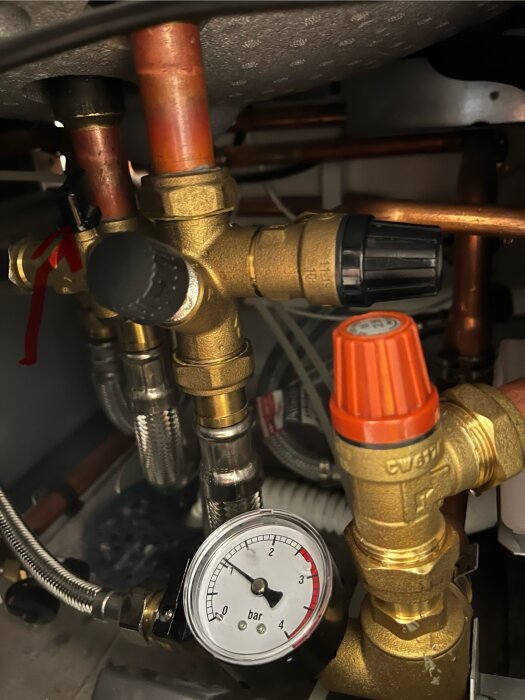 Rörsystem, kopparledningar, mässingsventiler, manometer, under diskbänk, rörinstallation, tryckmätare visar 1,5 bar.