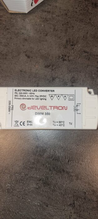 Elektronisk LED-omvandlare, 220-250V, dimbar, varumärket JEVELTRON, säkerhetsmärkningar, matt bakgrund.