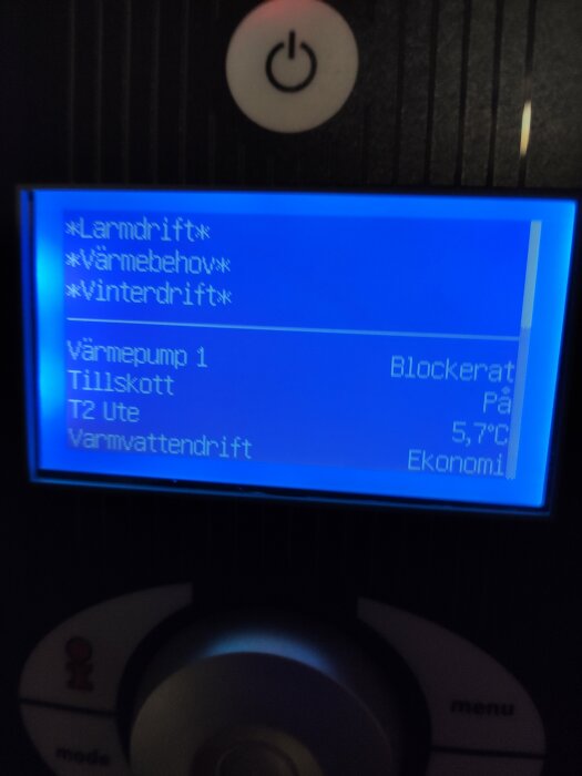 Digital display på en enhet för temperaturkontroll med menyalternativ, "blockerat" meddelande, och temperaturinformation.