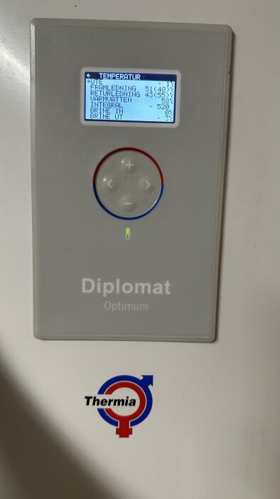 En värmepumpskontrollpanel som visar temperaturdata och status. Märke: Thermia Diplomat Optimum. Digital display och knappar.