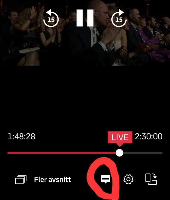 Publik klappar, live-event skärm, spelfunktioner, tidsindikator, mörk sal.
