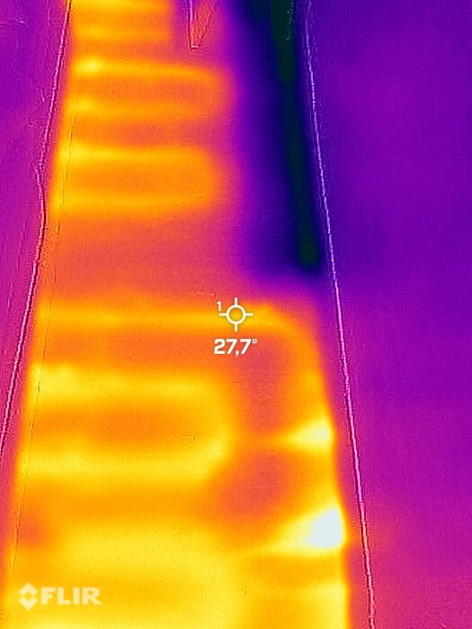 Termisk bild som visar värmevariationer, mönster på ytan, lila till gula färger, 27,7°C indikerat.