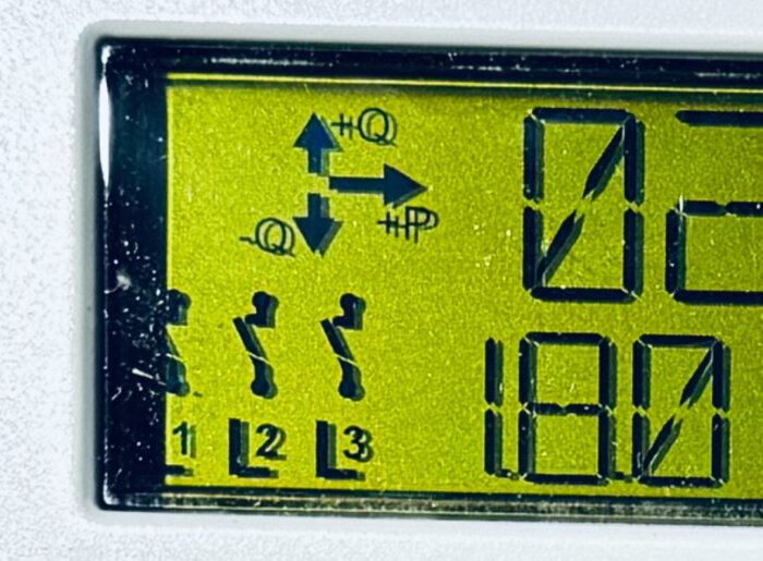 LCD-display med symboler, siffror och pengar. Skala, indikatorer för växling och två människofigurer.