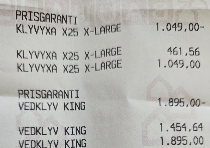 Kvitto som visar prismatchning och rabatterat pris på en yxa, slutpris 461,56 kr.