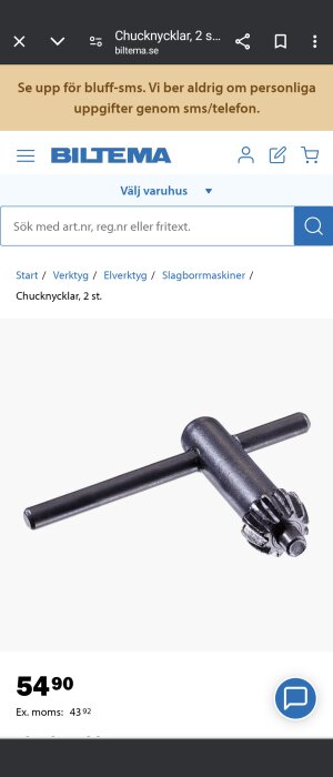 Chucknyckel i metall på en vit bakgrund som visas på en webbshoppssida.